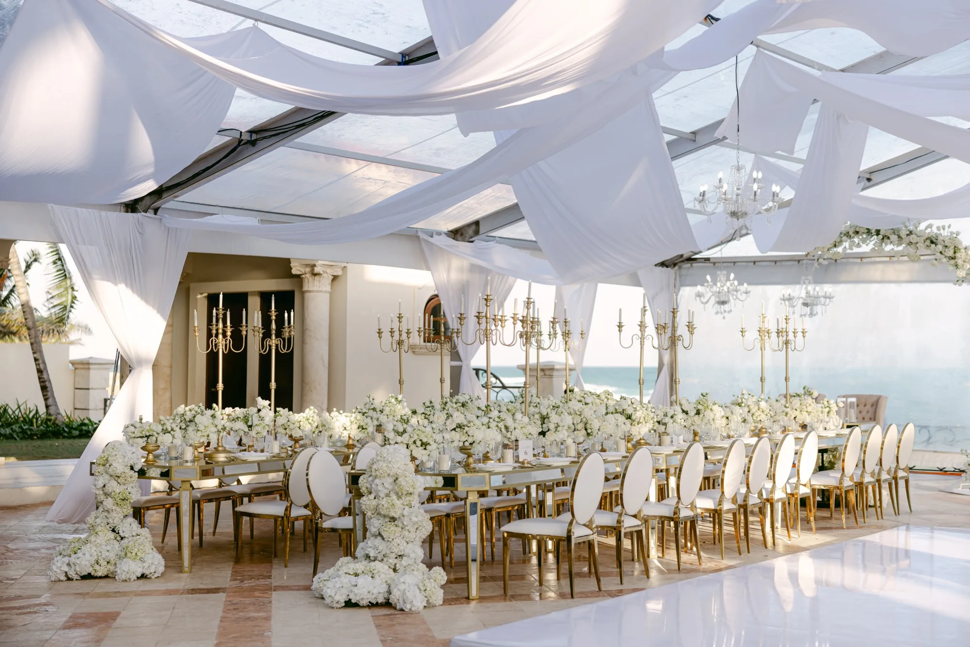 White and gold oceanfront reception tablescape — Villa La Joya